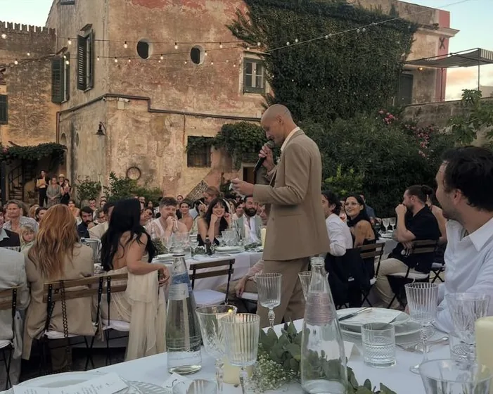 A long table dinner on a terrace at dusk
